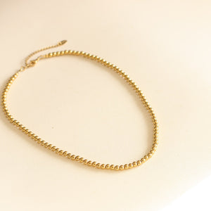 le cadeau simple collier à boules dorées