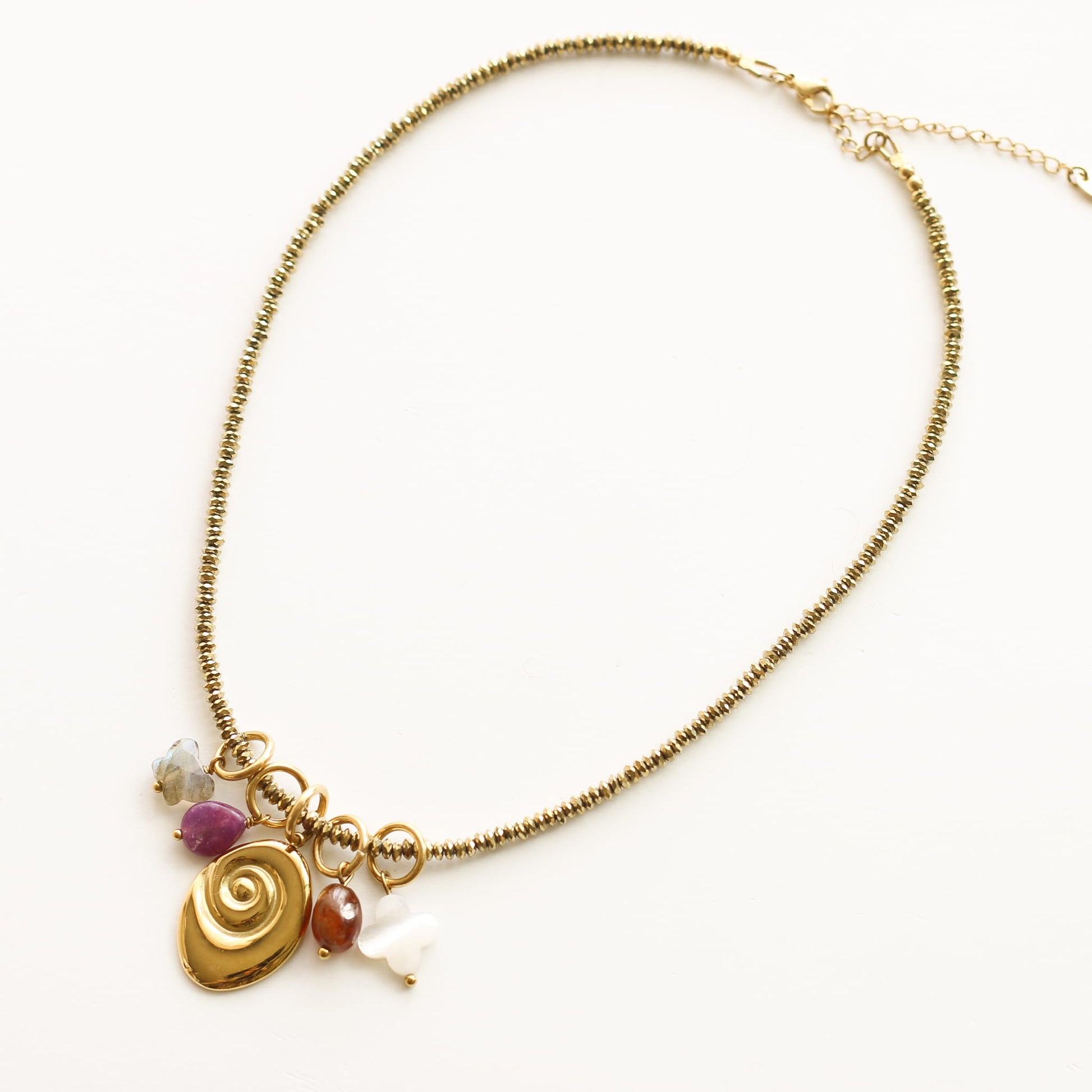 Collier Hématite dorée gri-gris, gros plan sur la pierre, création Mahny bijoux pierres semi-précieuses.